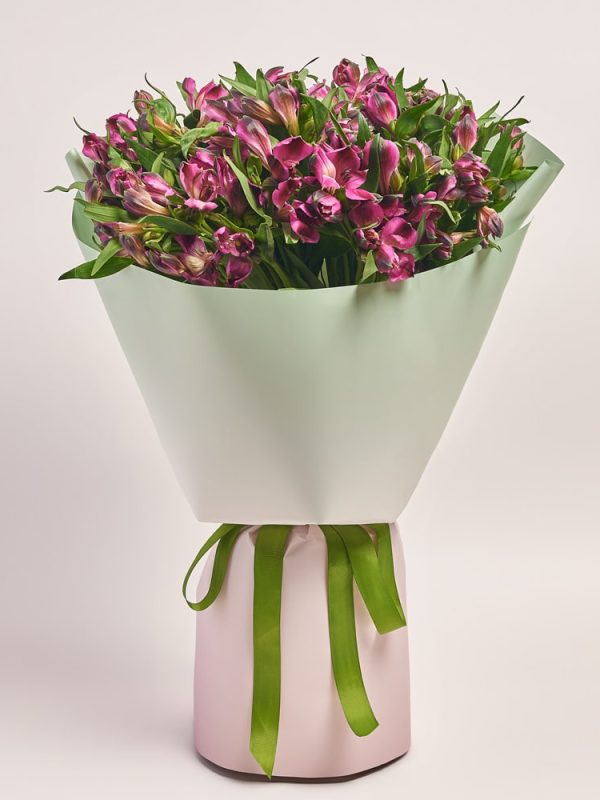 Elegant bouquet with vibrant pink flowers in a pastel wrap, flowers theme.